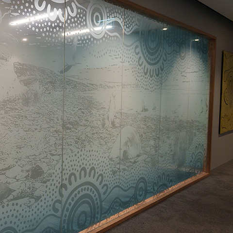 Artwork on meeting room glass walls representing a coastal theme.