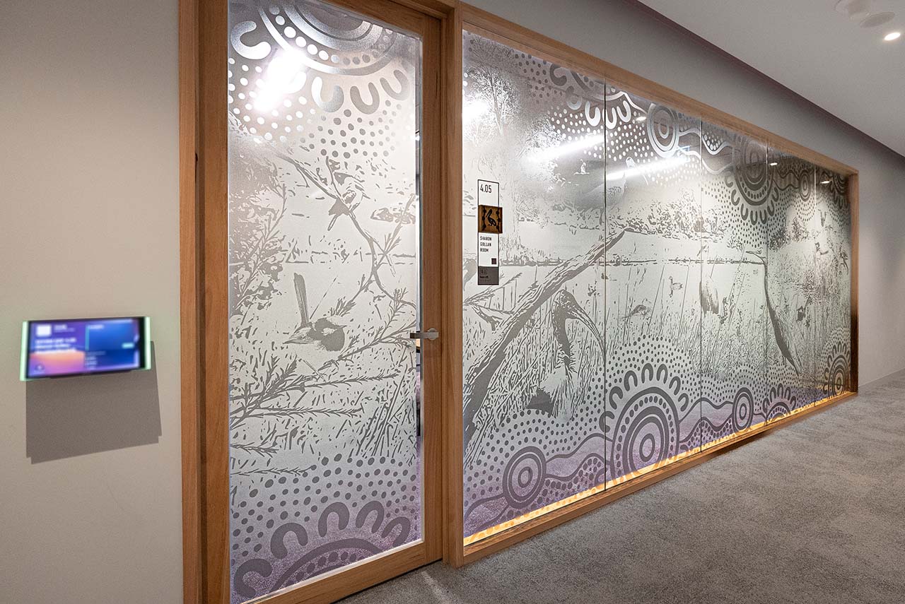 Artwotk on the glass walls of meeting rooms depicting the Lakes/Rivers theme.