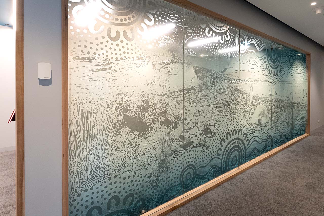 Artwotk on the glass walls of meeting rooms depicting the Coastal/Ocean theme.