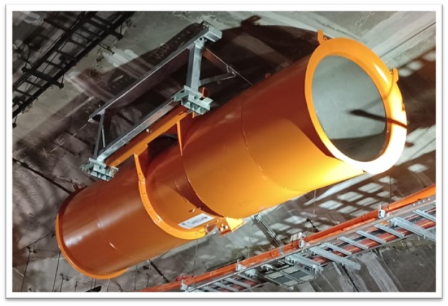 An orange fan being installed on the roof of the tunnel